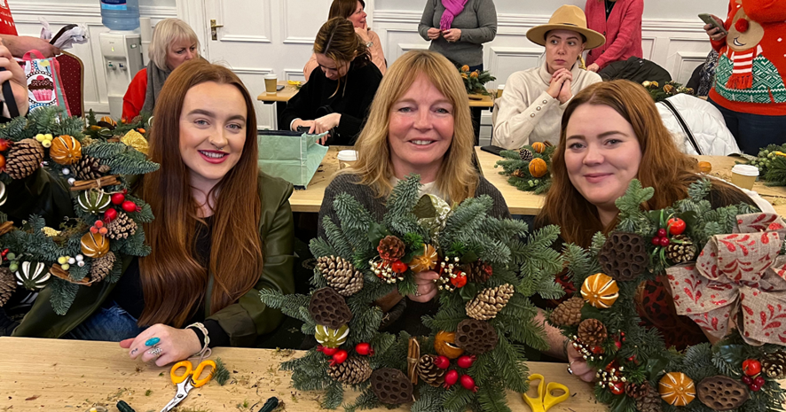 An image of three women at a wreath making workshop at Eastwood Park hotel. An activity for a unique Christmas party.