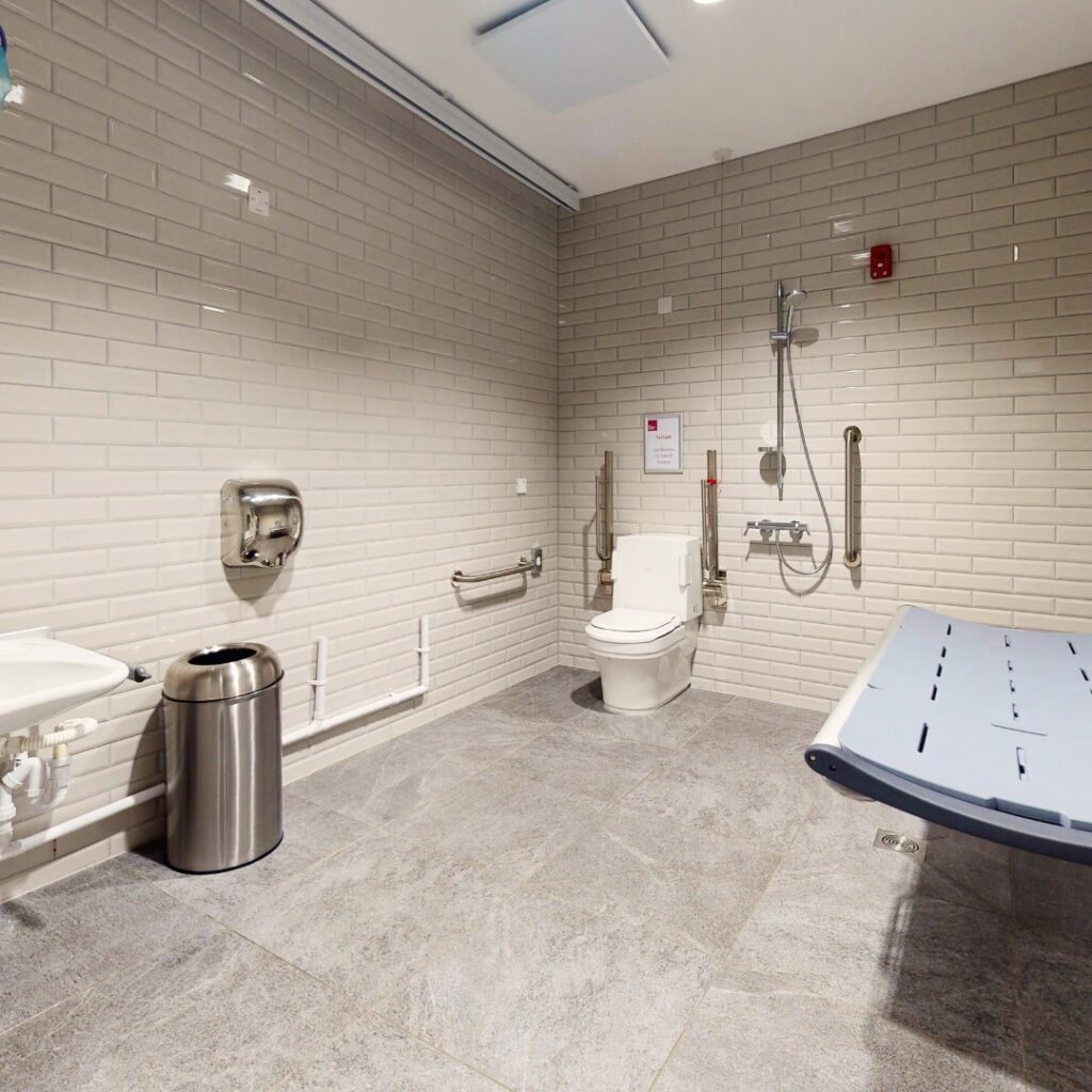 An image of a disabled bathroom with changing area.