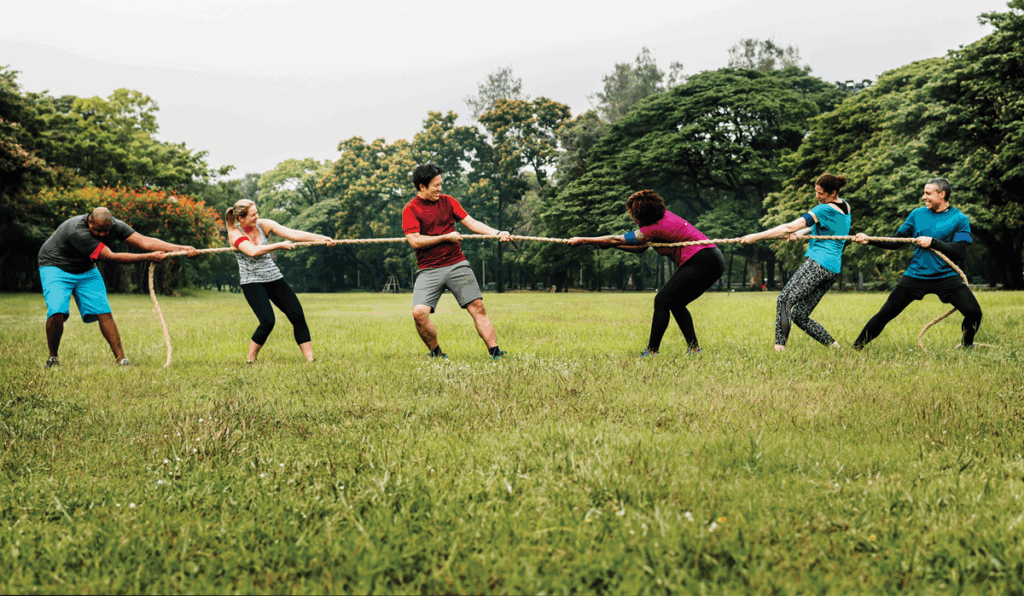 Image of people playing tug of war, one of the team building activities available at Denham Grove Hotel. 